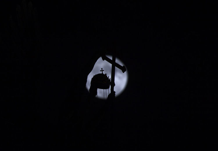 Low angle view of illuminated light against sky at night