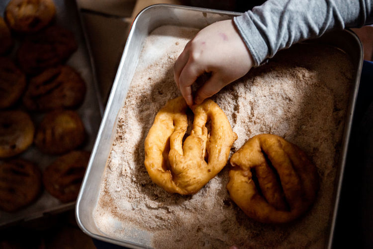 The preparation of a traditional food, sweet fritter called filhós from portugal. christmas time. 