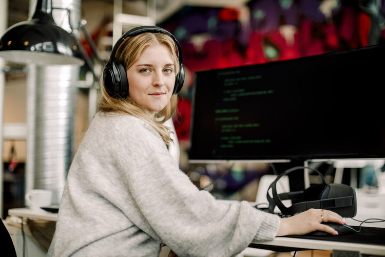 Portrait of female computer programmer sitting in office