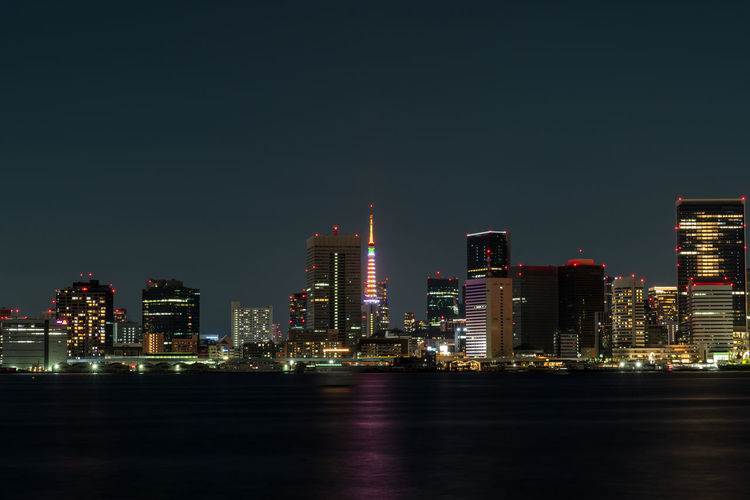 Illuminated city buildings against sky at night, tokyo - japan