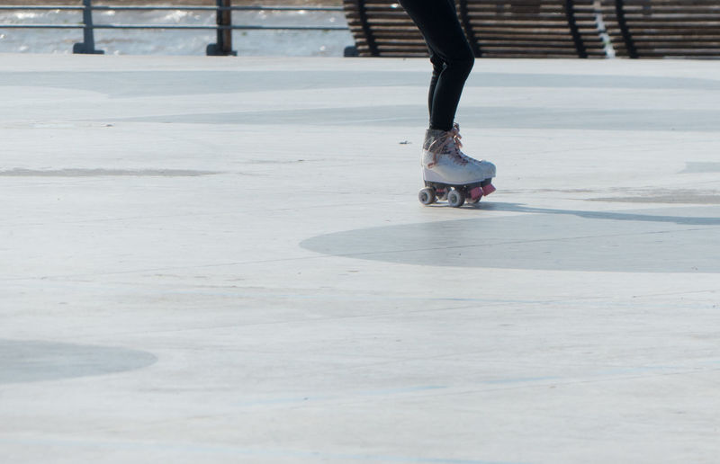 Low section of woman skating on park 