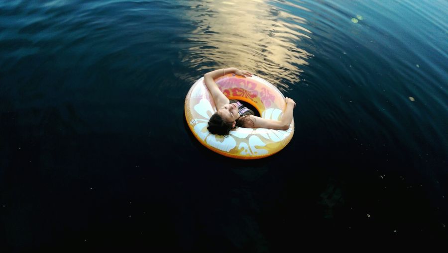 High angle view of woman with inflatable ring in lake