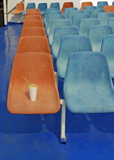 Close-up of empty chairs in row