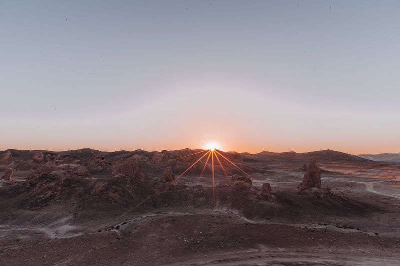 Scenic view of desert against sky during sunset