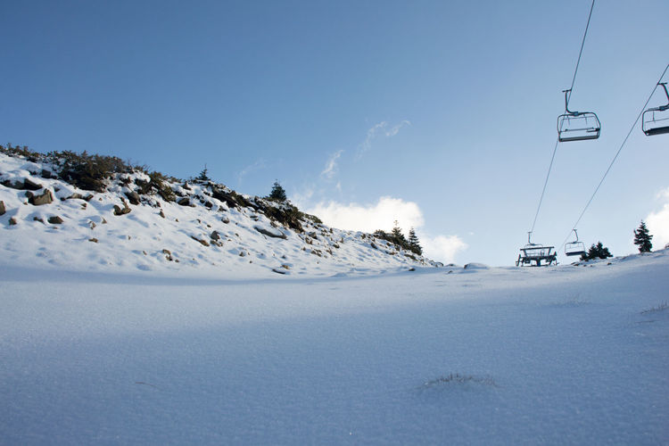 Pristine snow and cable car view as you climb the snow covered mountain top for winter tourism