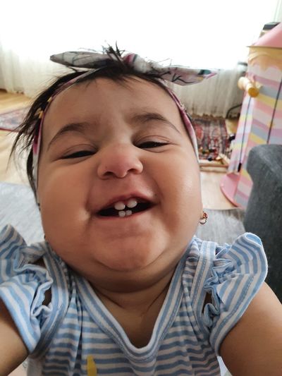 Portrait of smiling baby girl at home