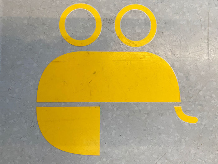 High angle view of yellow sign on road
