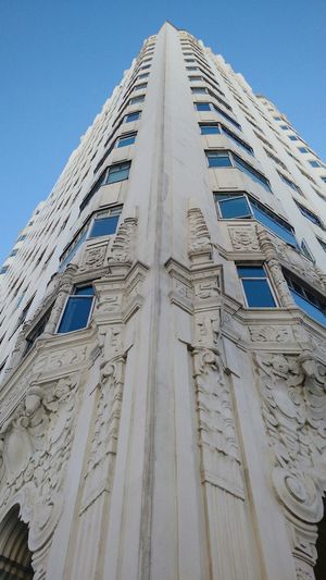 Low angle view of building against blue sky
