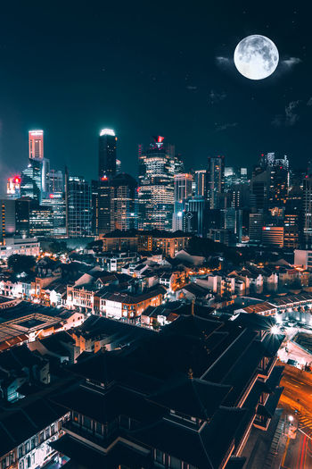 Illuminated cityscape against sky at night
