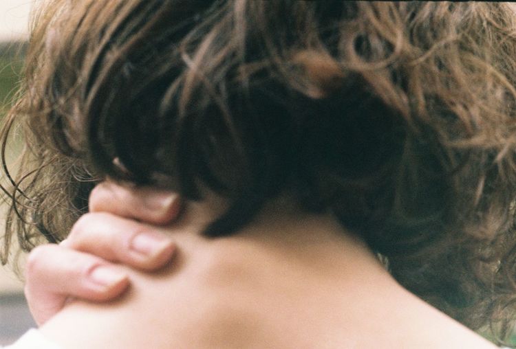 Close-up of woman holding aching neck