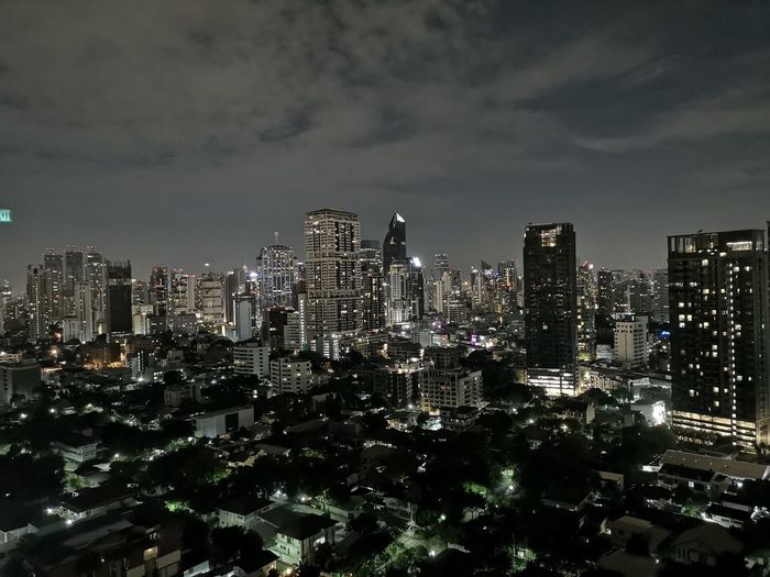 Illuminated cityscape against sky at night