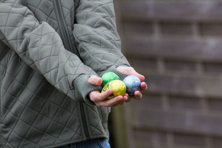 Cropped hand of person holding easter eggs