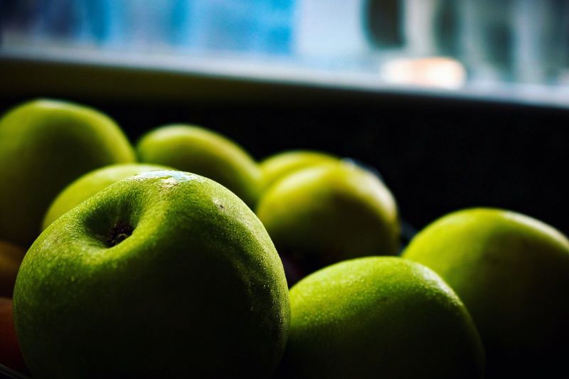 Close-up of granny smith apples on table