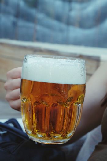 Cropped image of woman drinking beer