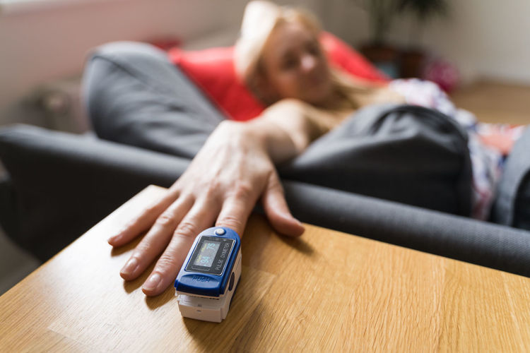 Close-up of woman hand with oximeter