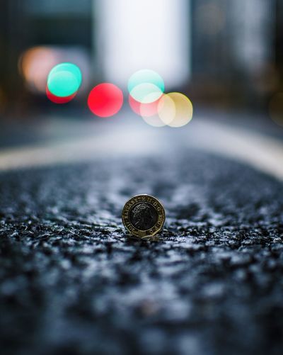 Close-up of coin on road
