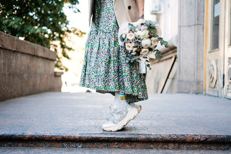 Contemporary modern trendy hipster bride in informal dress and sneakers with edible wedding bridal