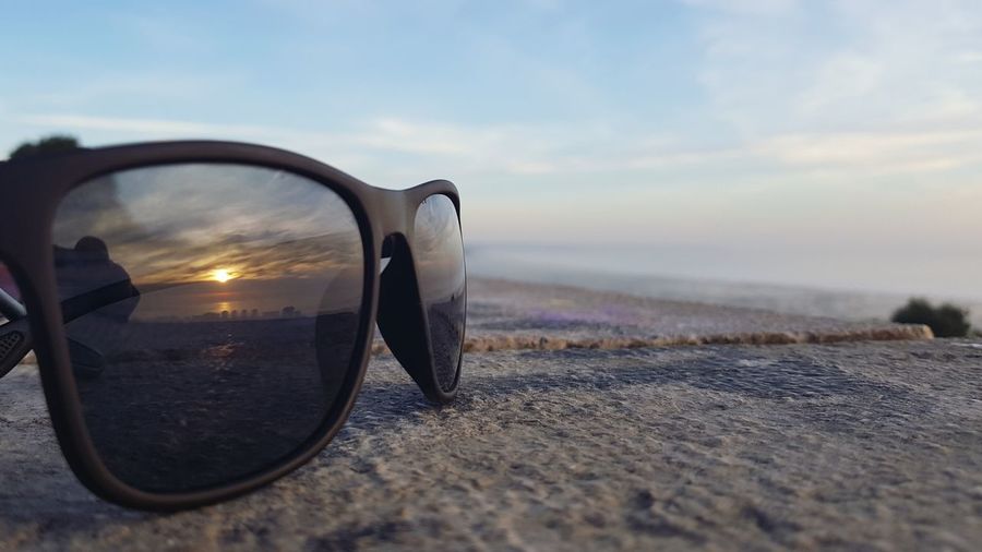 Close-up of sunglasses with sun reflection 