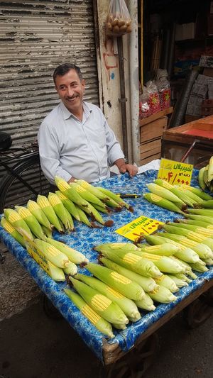 Portrait of a smiley merchant in market stall