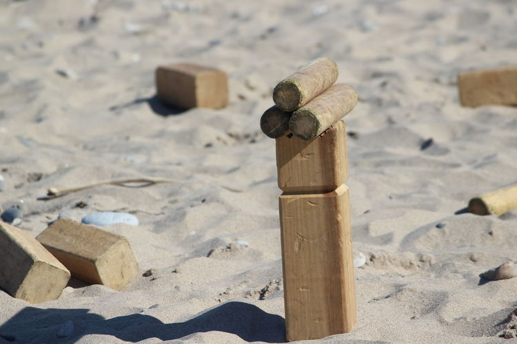 Close-up of wooden  game  on sand