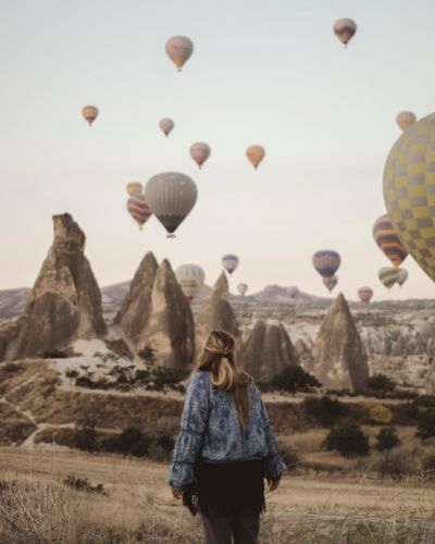 Rear view of woman with hot air balloons