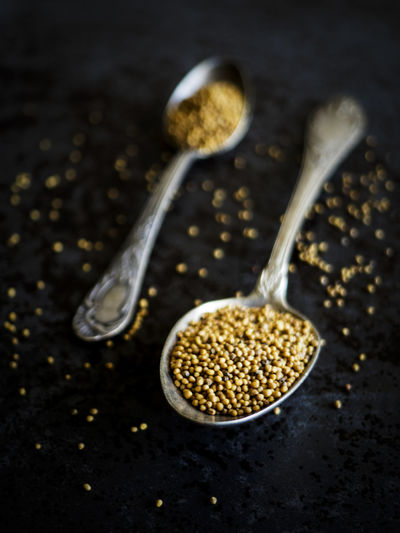 Close-up of mustard seeds in spoon on table