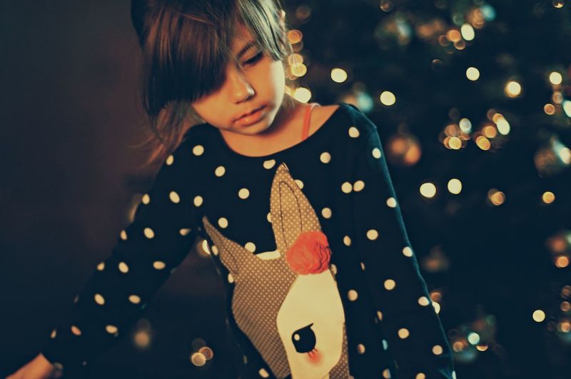 Girl standing against christmas decoration at home