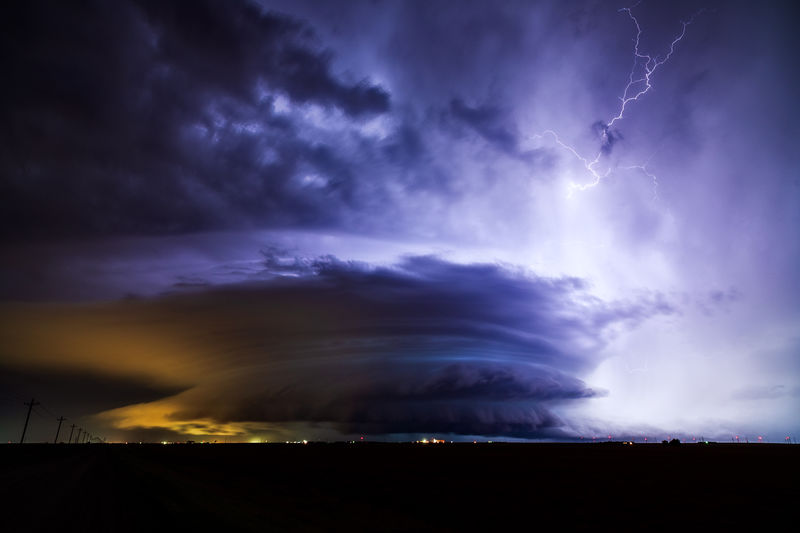 Lightning illuminates a powerful supercell thunderstorm over dodge city, kansas.