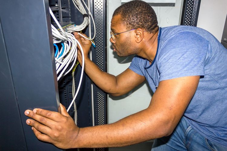 Close-up of man adjusting cable