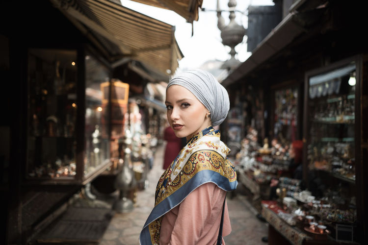 Woman standing amongst market stalls