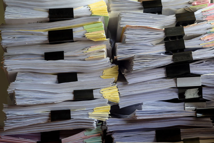 Full frame shot of documents stacked in office