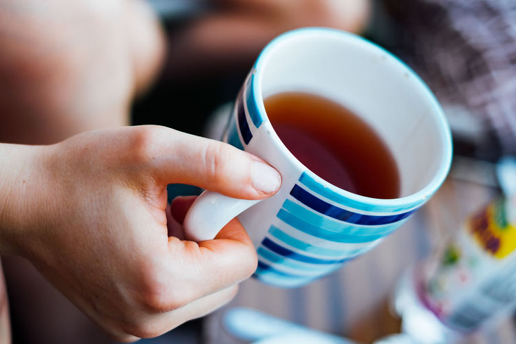 Close-up of person holding tea cup