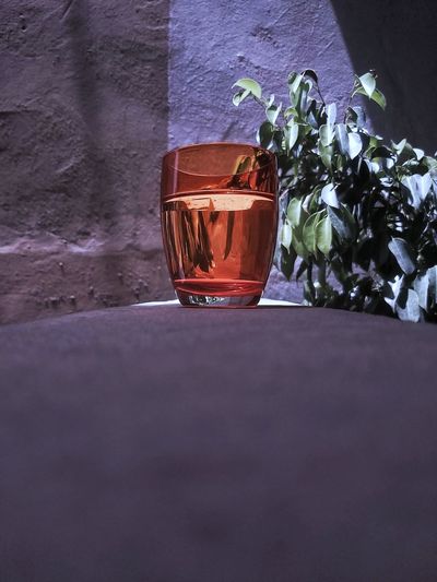 Close-up of drink on table against wall