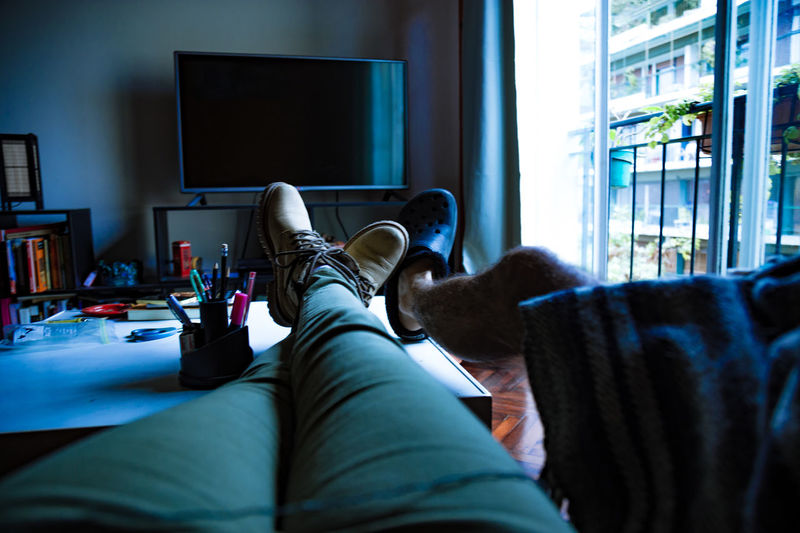 Low section of friends relaxing at home