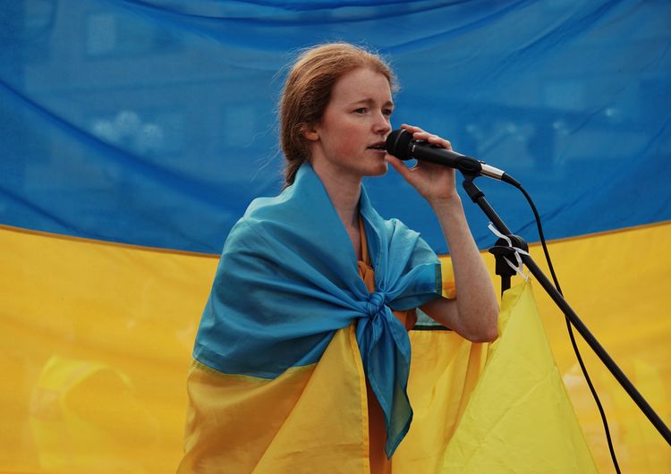 Side view of young woman with ukraine flag 