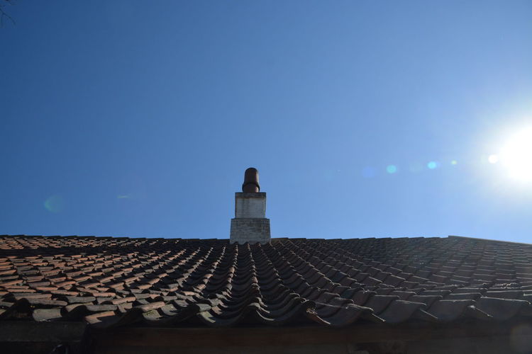 Low angle view of roof of building against clear sky