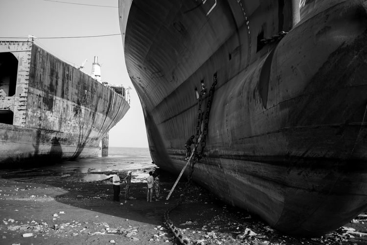 Abandoned boat  in shipyard against sky