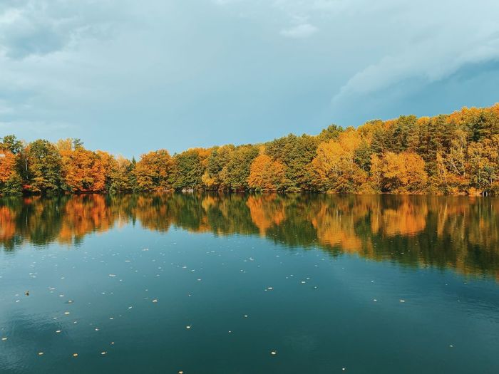 Reflection of trees in lake against sky during autumn