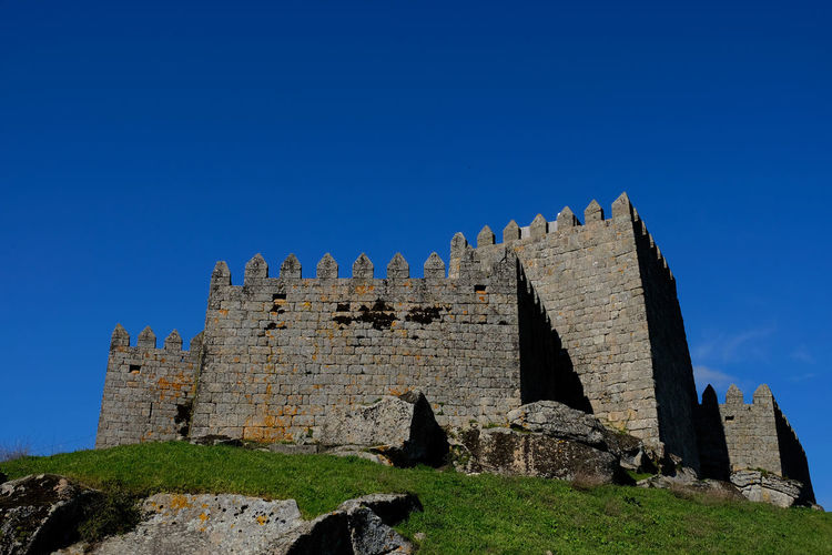 Low angle view of castle against blue sky