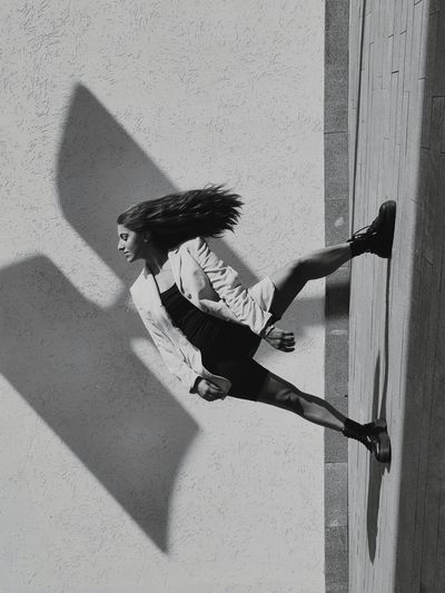 Side view of woman shadow on wall
