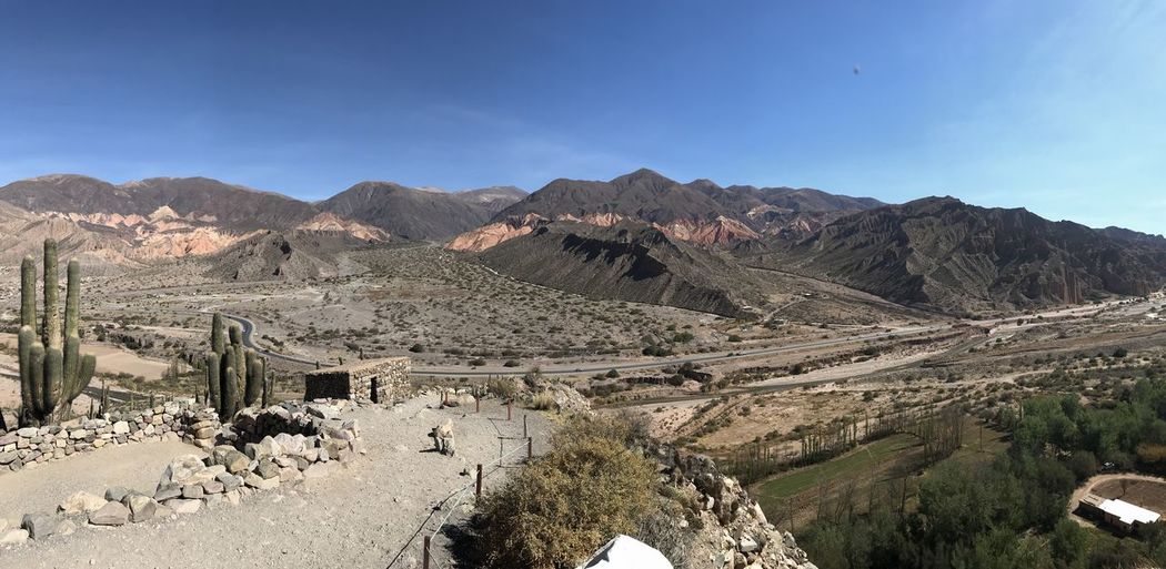 Panoramic view of landscape against blue sky