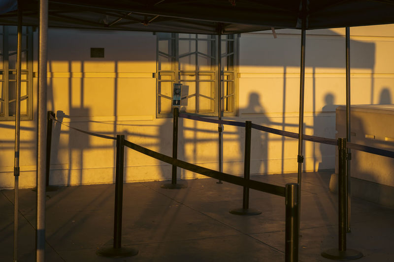 Empty line queue at sunset with silhouettes 