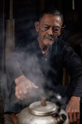 Portrait of senior man working at workshop