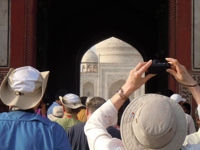 Group of people clicking photo of taj mahal
