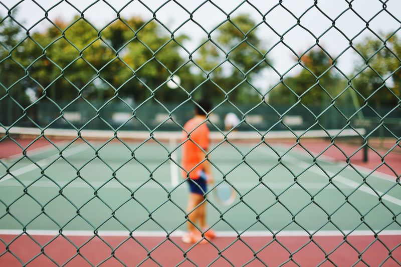 Close-up of chainlink fence against sky