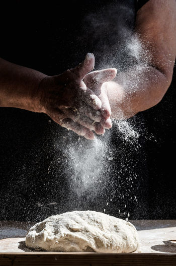 Close-up of hands making a cake