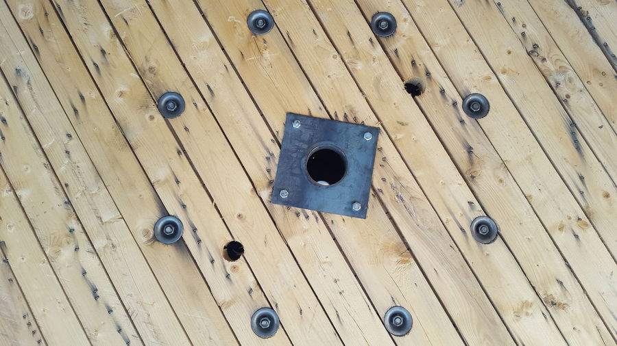 High angle view of bolts and nuts on wooden table