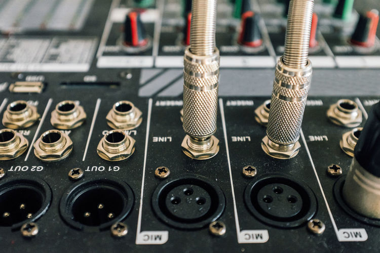 Close-up of jacks connected to sound mixer in recording studio