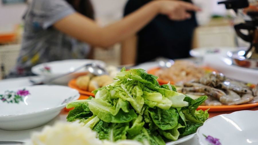 Close-up of salad on table with women in background