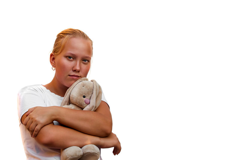 Portrait of boy with toy against white background